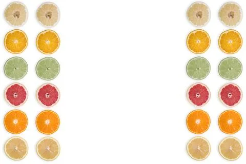 Multi-colored citrus slices on a white background Stock Photos