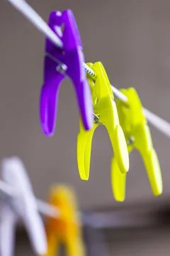 Multi-colored clothespins on a rope Stock Photos