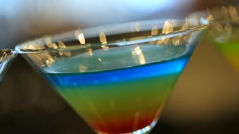 Multi colored cocktail drink in martini glass at bar B Stock Footage 120407826