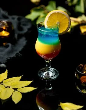 Multi-colored cold drink with an orange slice Stock Photos