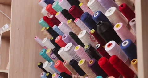 Multi-colored cones threads wall at the production evening dresses. overall plan Stock Footage 170054162