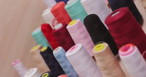 Multi-colored cones threads wall production of evening dresses. dynamic filming Stock Footage 170054322