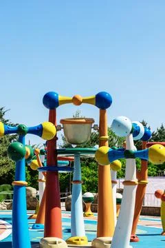 Multi-colored construction with a bucket for water upstairs on a bright area in Stock Photos