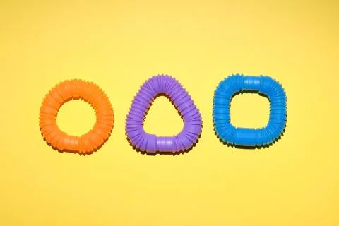 Multi-colored corrugated plastic pipes on a bright background Stock Photos