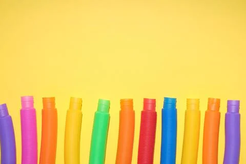 Multi-colored corrugated plastic pipes on a bright background Stock Photos