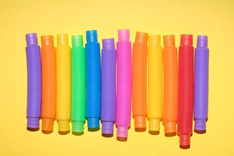 Multi-colored corrugated plastic pipes on a bright background Stock Photos