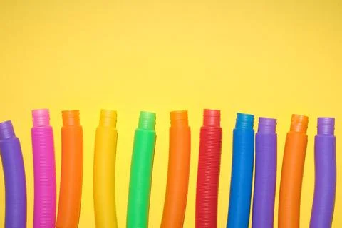 Multi-colored corrugated plastic pipes on a bright background Stock Photos