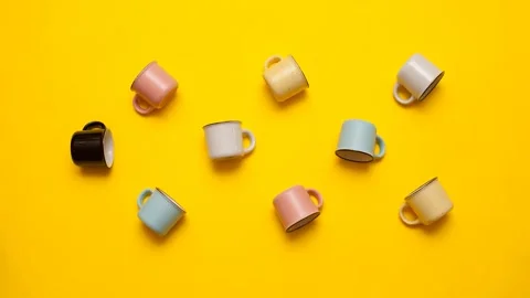 Multi-colored cups that lie on their sides spin on their axis Video stock 141650573