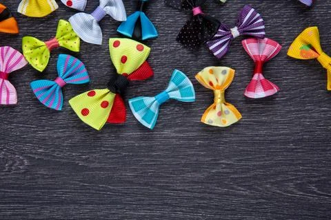 Multi-colored decorative fabric bows on a wooden table top view Stock Photos