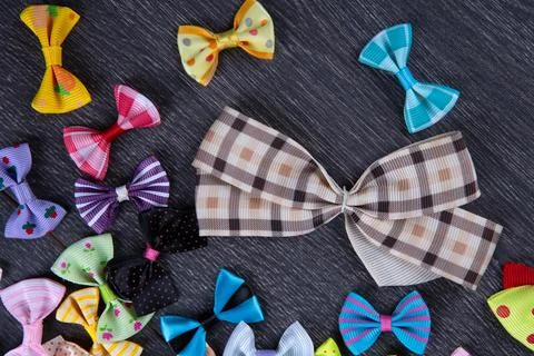 Multi-colored decorative fabric bows on a wooden table top view Stock Photos