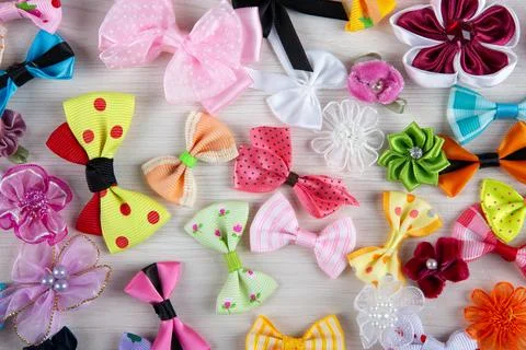 Multi-colored decorative fabric bows on a wooden table top view Stock Photos