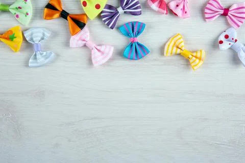Multi-colored decorative fabric bows on a wooden table top view Stock Photos