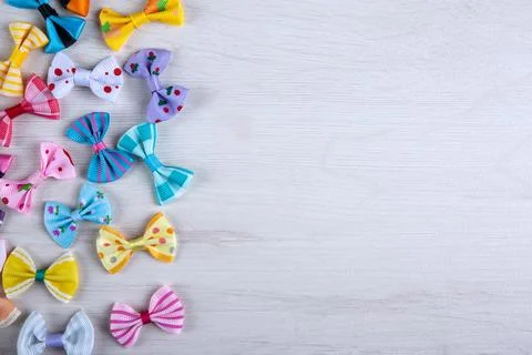Multi-colored decorative fabric bows on a wooden table top view Stock Photos
