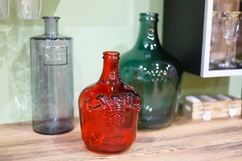 Multi-colored decorative large bottles, in the foreground red, in the background Stock Photos