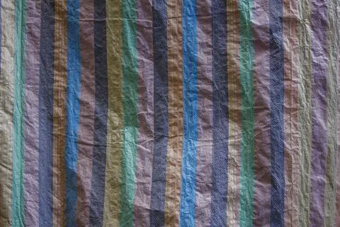 Multi-colored dense canvas wrinkled fabric with vertical lines. rough surface Stock Photos
