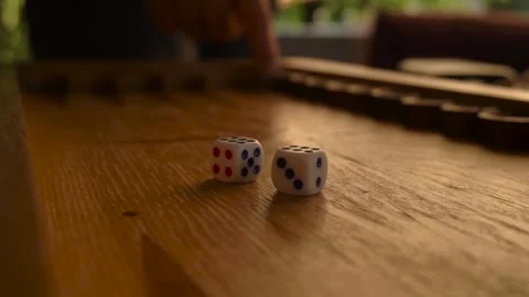 Multi-colored dice lie on wooden board for backgammon. player prepares to move Stock Footage 161190408