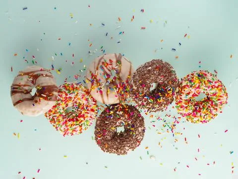 Multi-colored donuts covered with sugar icing, confectionery and chocolate on Stockfoto's