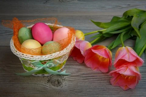 Multi-colored Easter eggs and sweets in a beautiful basket. Stock-Fotos