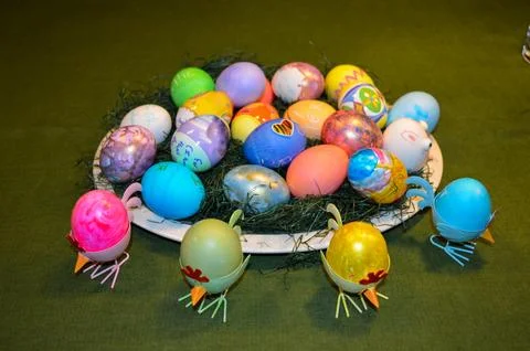 Multi-Colored Easter Eggs in a Basket on a Table Stock Photos