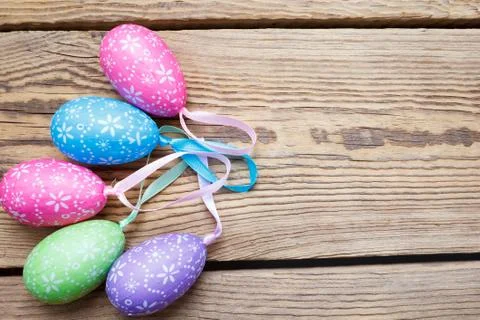 Multi-colored Easter eggs lie on a wooden board Stock Photos