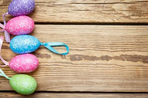 Multi-colored Easter eggs lie on a wooden board Stock Photos