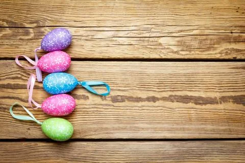 Multi-colored Easter eggs lie on a wooden board Stock Photos