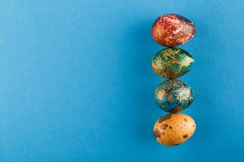 Multi-colored Easter eggs lie in a row. Stock Photos