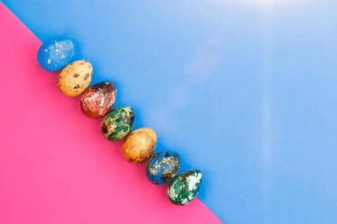 Multi-colored Easter eggs lie in a row. Stock Photos