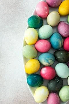 Multi-colored Easter eggs in an oval dish ,Happy Easter holiday Stock Photos