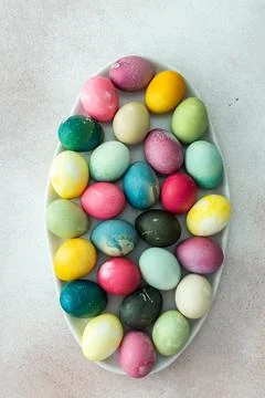 Multi-colored Easter eggs in an oval dish ,Happy Easter holiday Stock Photos