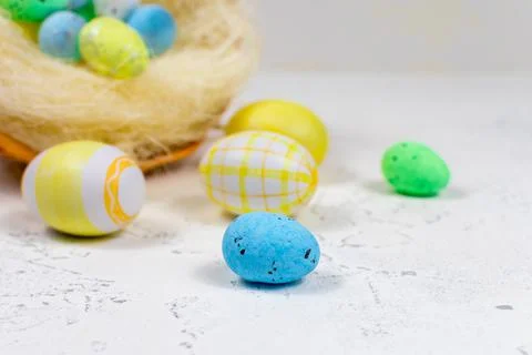 Multi-colored Easter eggs painted in pastel colors on a white table against the Stock Photos