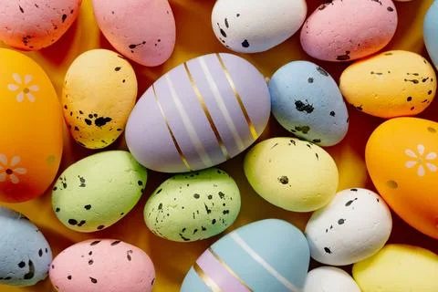 Multi-colored Easter eggs on a yellow spring background. Happy easter Stock Photos