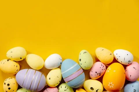 Multi-colored Easter eggs on a yellow spring background. Happy easter Stock Photos