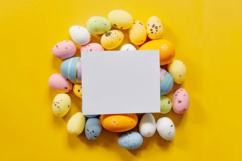 Multi-colored Easter eggs on a yellow spring background. Happy easter Stock Photos