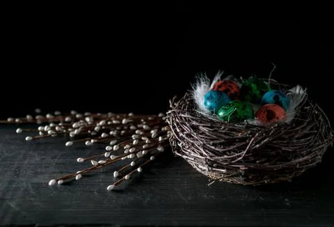 Multi-colored eggs on a dark background. Easter still life in a low key. Dark Stock Photos