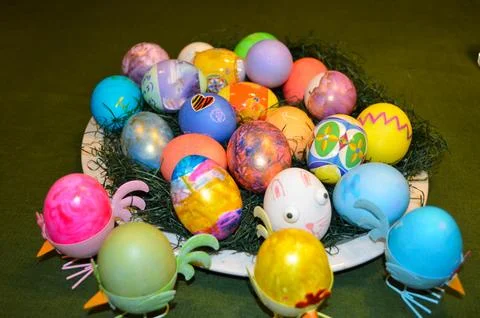 Multi-Colored Eggs Placed in a Basket on a Table Stock Photos