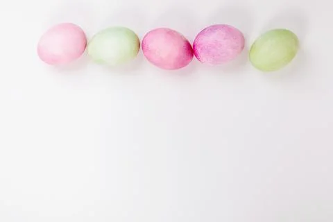 Multi-colored eggs with twigs, on a white background with a place for text. Stock Photos