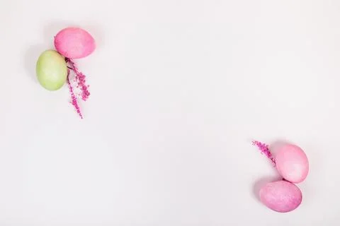 Multi-colored eggs with twigs, on a white background with a place for text. Stock Photos