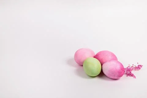 Multi-colored eggs with twigs, on a white background with a place for text. Stock Photos