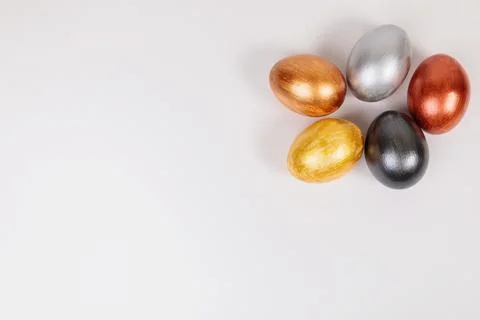 Multi-colored eggs on a uniform white background with place for text. Stock Photos