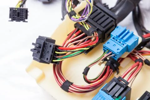 Multi-colored electrical wires with car connectors on a white isolated backgr Stock Photos