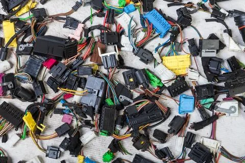 Multi-colored electrical wires with car connectors on a white isolated back.. Stock Photos