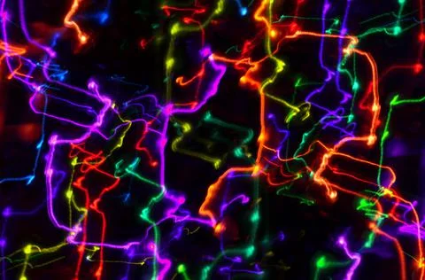 Multi-colored explosion of lights on dark background Stock Photos