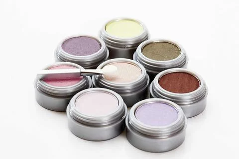 Multi colored eye shadows with make up brush on white background Stock Photos
