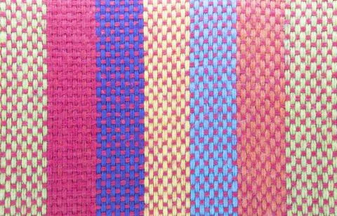 Multi colored fabric texture as a background. Stock Photos