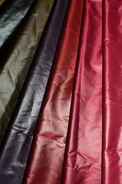 Multi-colored fabrics with a smooth texture and rich shades. Stock-Fotos