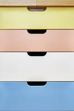 Multi-colored facades of roll-out drawers for stationery Stock Photos