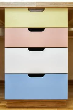 Multi-colored facades of roll-out drawers for stationery Stock Photos