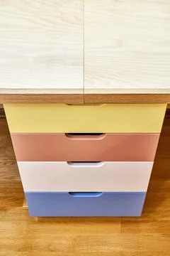 Multi-colored facades of roll-out drawers for stationery Stock Photos
