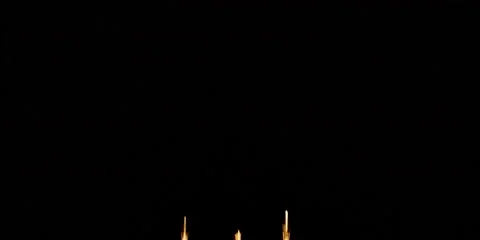 Multi-colored fan filling the sky while starbursts follow in fireworks display Stock Footage 59122049